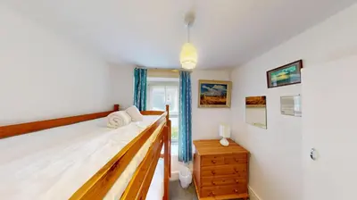 a bedroom with a bed and a window at St Ives Gazelle Cottage 2 Bedrooms in St Ives