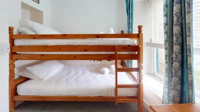 a bunk bed in a room with a window at St Ives Gazelle Cottage 2 Bedrooms in St Ives