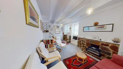 a living room with a couch and a fireplace at St Ives Gazelle Cottage 2 Bedrooms in St Ives