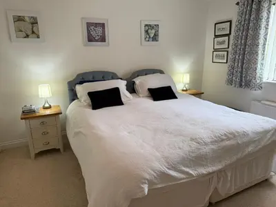 a bedroom with a large white bed with two pillows at Wadebridge, 14 St Matthews Hill in Wadebridge