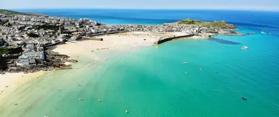 an aerial view of a beach with people in the water at St Ives apartment less than 5 minutes walk to beach parking available in St Ives