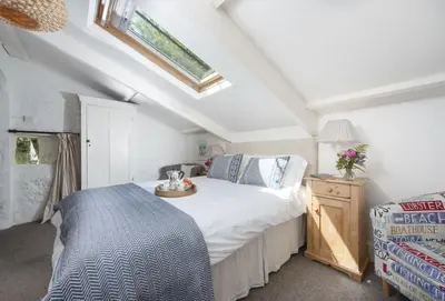 a bedroom with a bed with a tray on it at The Watermill in Bodmin