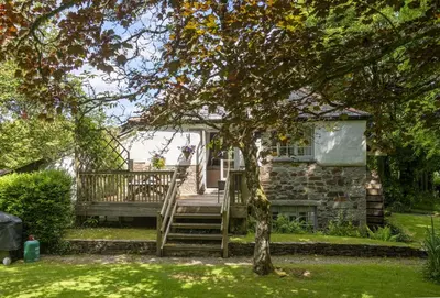 a house with a staircase leading up to a house at The Watermill in Bodmin