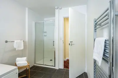 a bathroom with a shower and a glass door at Stradav in Polzeath