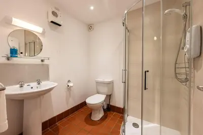 a bathroom with a toilet and a sink and a shower at Stradav in Polzeath
