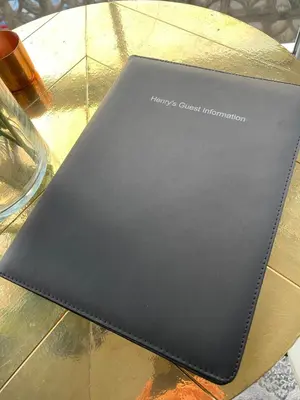 a black notebook sitting on top of a table at Henrys in St Ives