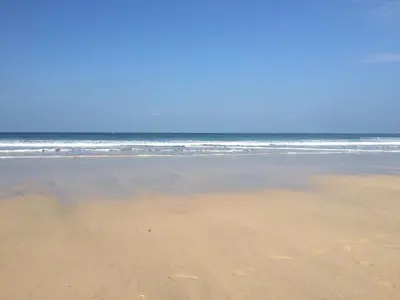 an empty beach with the ocean in the background at Henrys in St Ives