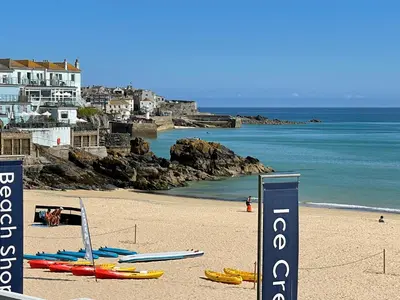 a beach with a bunch of surfboards on the sand at Henrys in St Ives