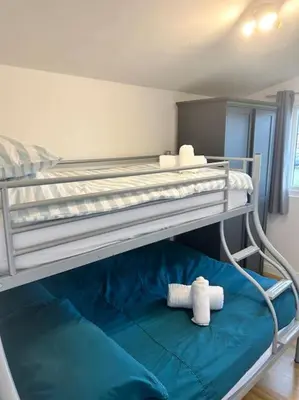 a bedroom with two bunk beds with towels on them at Spacious cabin, near Padstow and 7 Bays in St Merryn
