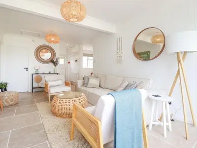 a living room with a couch and a table at Polwen in Padstow