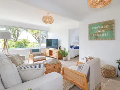 a living room with a couch and a tv at Polwen in Padstow