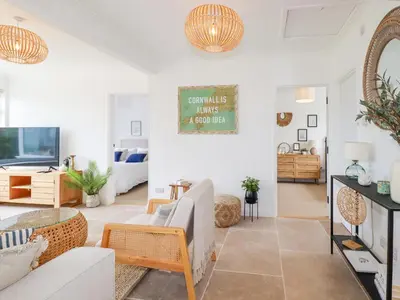 a living room with a couch and a tv at Polwen in Padstow