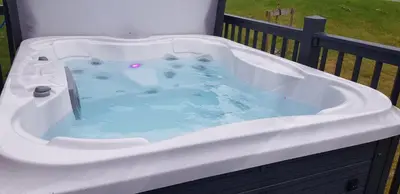 a jacuzzi tub sitting on a balcony at Holiday Home with a Hot tub in St Austell