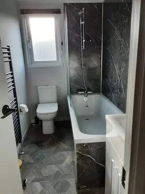a bathroom with a toilet and a tub and a sink at Holiday Home with a Hot tub in St Austell