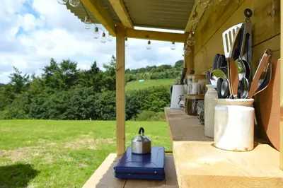 a table with a pot and utensils on it at Tylda Tents at Tregonetha Lake - 5m Luxury Bell Tent 