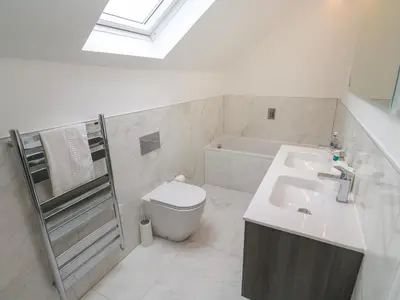 a white bathroom with a sink and a toilet at Amelia's Point in St Ives
