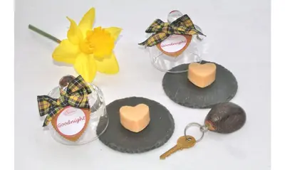 a group of cookies and keys and a yellow flower at Seven Bed and Breakfast in St. Agnes