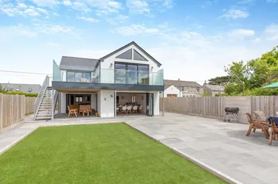 a house with a patio and a lawn at 4 Bed in Windmill oc-w29654 in St Merryn