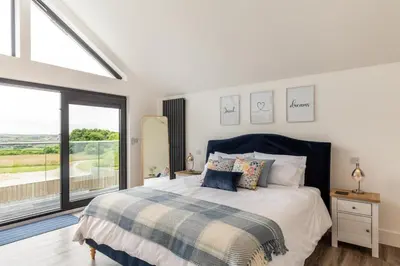 a bedroom with a bed and a large window at 4 Bed in Windmill oc-w29654 in St Merryn