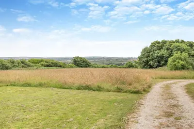 a dirt road in the middle of a field at 4 Bed in Windmill oc-w29654 in St Merryn