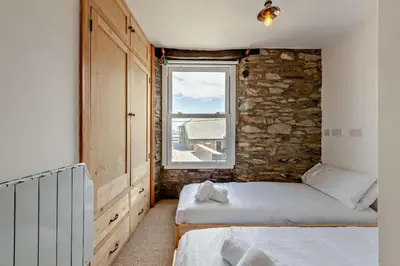a bedroom with two beds and a window at 2 Bed in Looe oc-a29612 in Looe