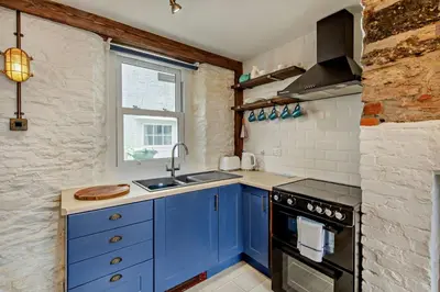 a blue kitchen with a sink and a stove at 2 Bed in Looe oc-a29612 in Looe