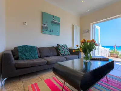 a living room with a couch and a coffee table at Seaspray in St Ives