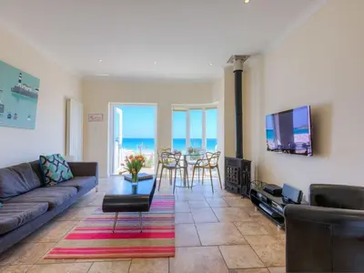 a living room with a couch and a table at Seaspray in St Ives