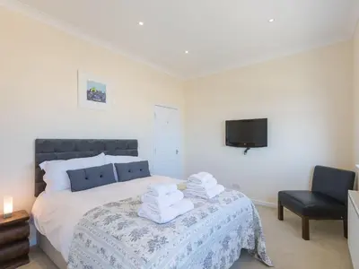 a bedroom with a bed with towels on it at Seaspray in St Ives