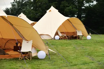 a group of tents sitting in the grass at Tylda Tents at Heydaze Campsite - 5m Luxury Bell Tent 