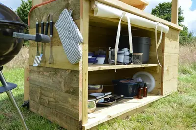 a wooden cabinet filled with lots of pots and pans at Tylda Tents at Heydaze Campsite - 5m Luxury Bell Tent 