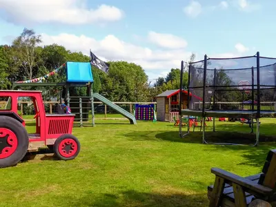 a playground with a red toy truck in a park at The Linney-Uk12576 in Bodinnick