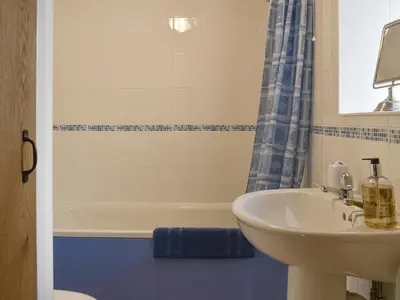 a bathroom with a sink and a bath tub at The Linney-Uk12576 in Bodinnick