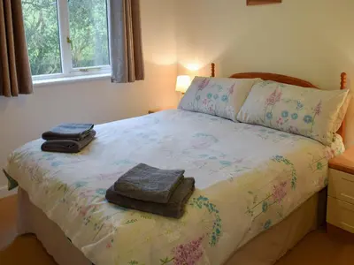 a bedroom with a bed with two towels on it at Gull Cottage in Falmouth