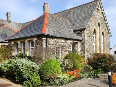 an old stone church with a gray roof at Honeysuckle Cottage in Padstow