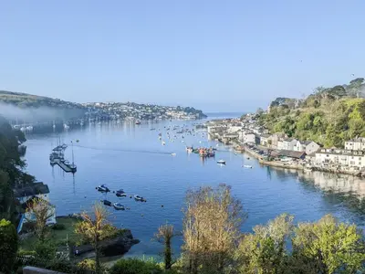 a view of a river with boats in a city at Harbourside in Fowey