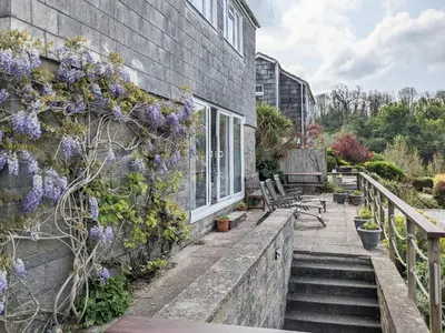 a house with purple flowers on the side of it at Harbourside in Fowey