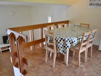 a dining room table and chairs with a polka dot table cloth at Harbourside in Fowey