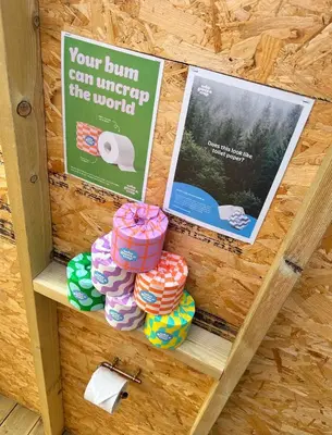 a shelf with pamphlets and signs on a wall at Lakeside Glamping Kingfisher in Saint Columb Major