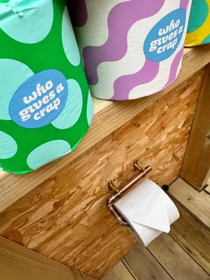 a roll of toilet paper on the floor next to a drawer at Lakeside Glamping Firecrest in Saint Columb Major