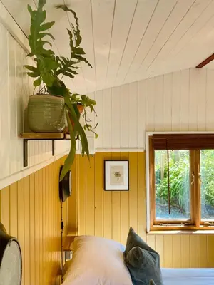 a bedroom with a potted plant on the wall at The Garden Room - Cabin on The Lizard in Cury
