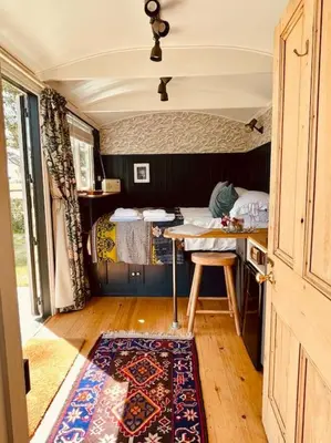 a small room with a table and a bed at The Field Room - Hut on The Lizard in Helston