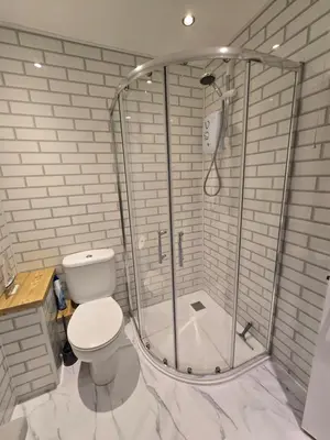 a bathroom with a shower with a toilet in it at Seven Bays in Newquay