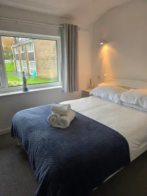 a bedroom with a bed with a towel on it at Seven Bays in Newquay