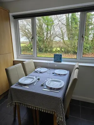 a dining room table with a blue and white table cloth at Seven Bays in Newquay