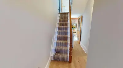 a spiral staircase in a house with a hallway at St Ives Bubblegum Cottage in St Ives