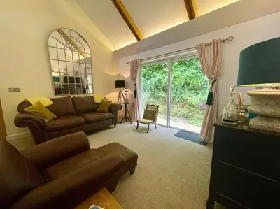 a living room with a couch and a window at Cornwall Truro Falmouth cottage in Perranwell
