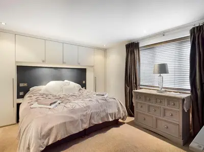 a bedroom with a large bed and a window at Cornwall Truro Falmouth cottage in Perranwell