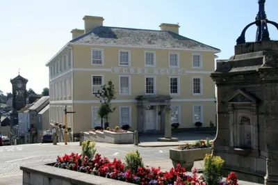 a yellow building with a writers house on a street at Webbs House Apartment 3 in Liskeard