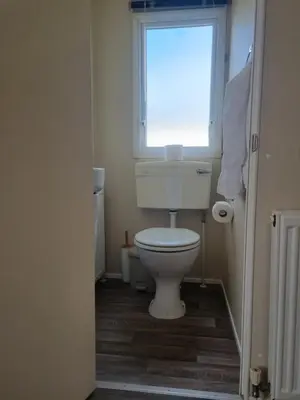 a bathroom with a white toilet and a window at Chapmans Holiday Home Newquay in Newquay